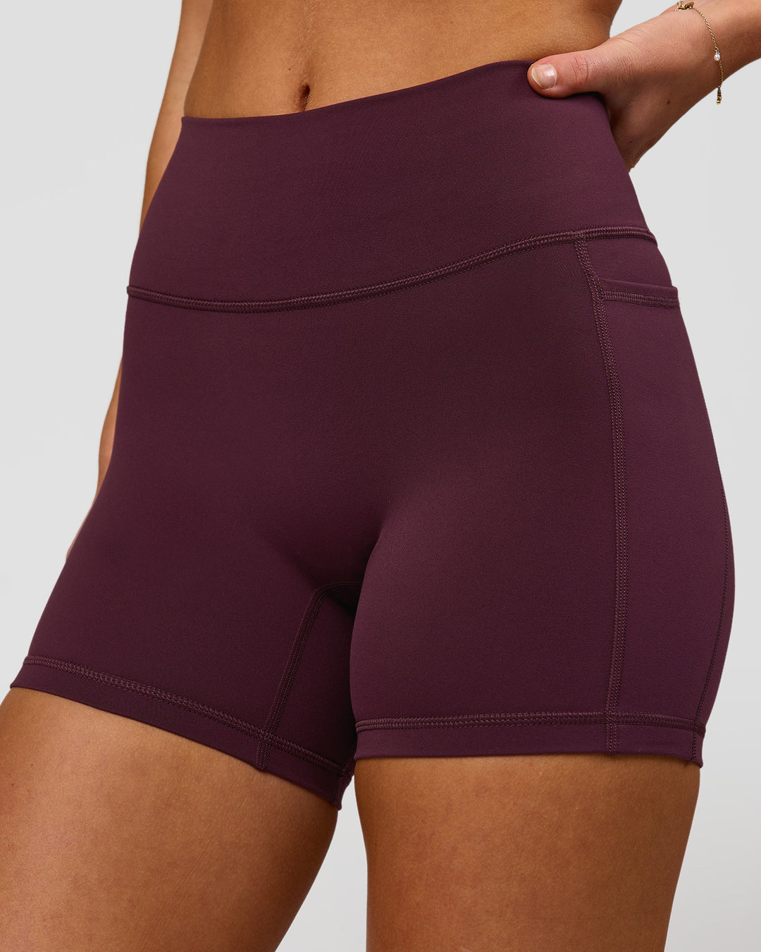 Woman wearing Fusion High-Rise 4" Short Pockets - Cherry Lacquer | Model:Issy | Size:XS - view 1
