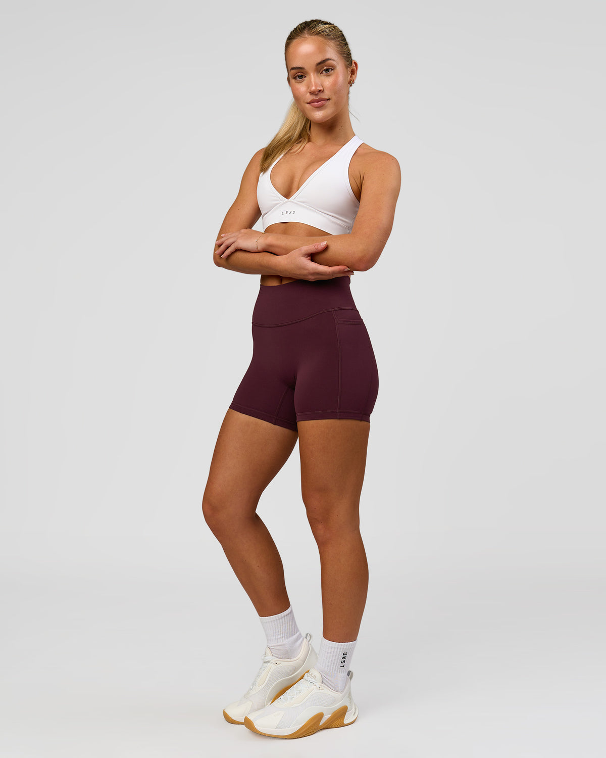 Woman wearing Fusion High-Rise 4" Short Pockets - Cherry Lacquer | Model:Issy | Size:XS