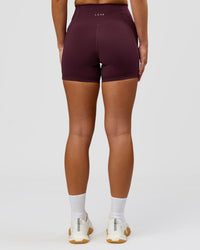 Woman wearing Fusion High-Rise 4" Short Pockets - Cherry Lacquer | Model:Issy | Size:XS | Thumbnail Index: 7