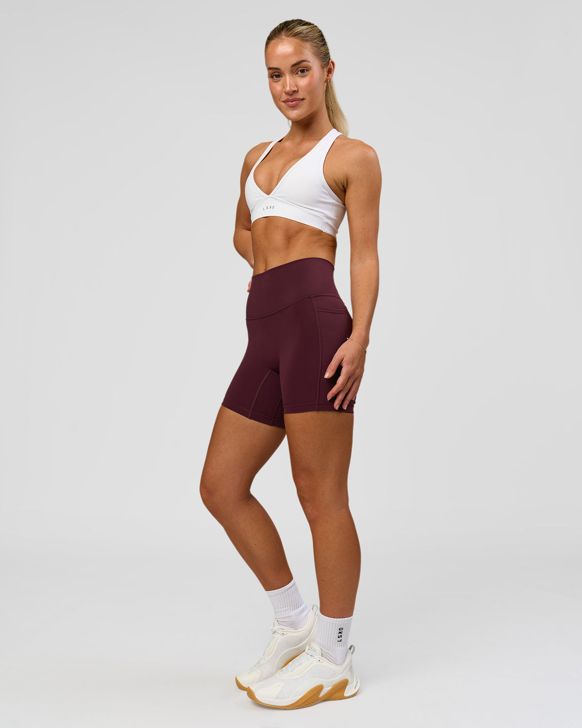 Woman wearing Fusion High-Rise 6" Short Pockets - Cherry Lacquer | Model:Issy | Size:XS
