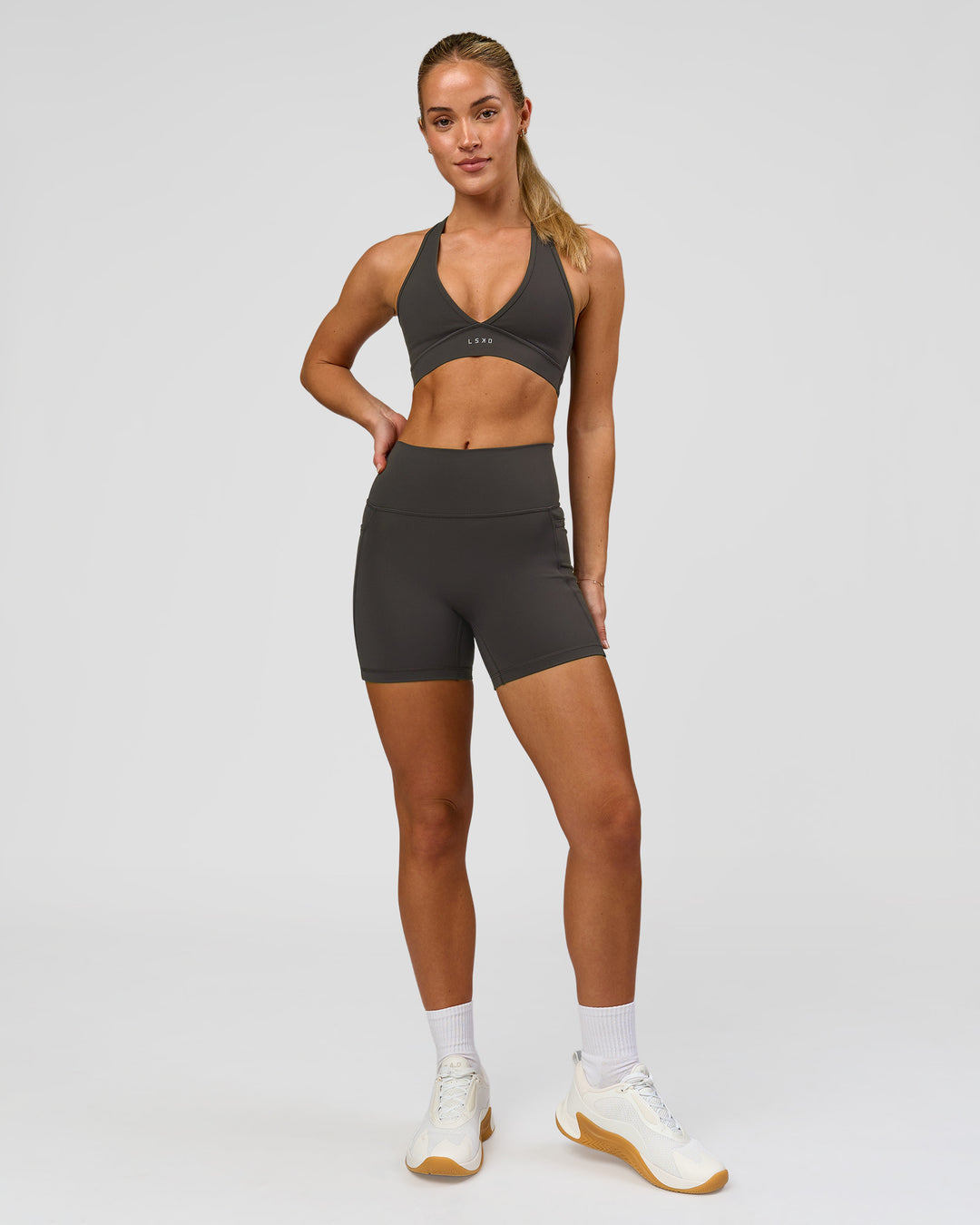 Woman wearing Fusion Ultra High-Rise 4" Short Pockets - Onyx | Model:Issy | Size:XS - view 5