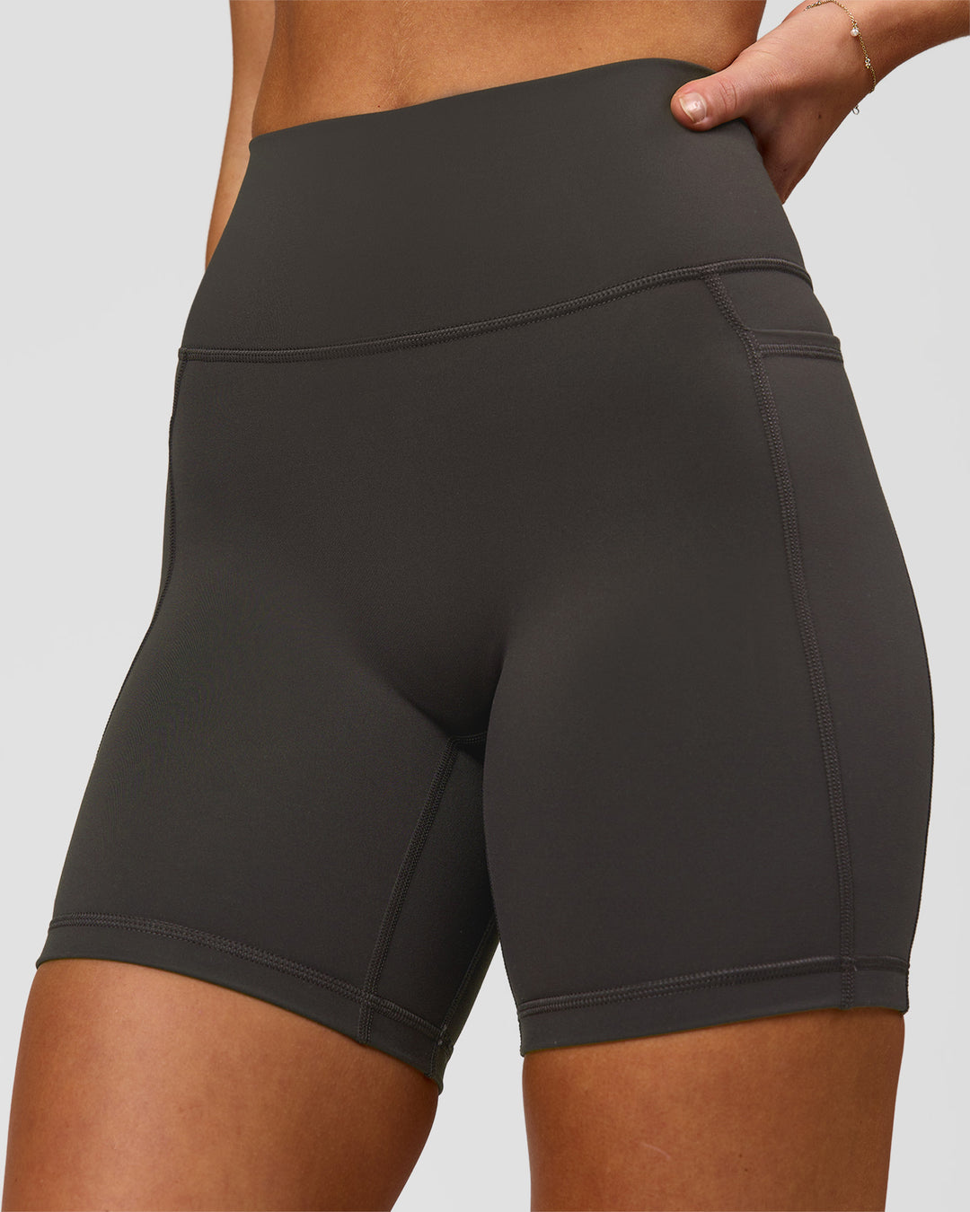 Woman wearing Fusion Ultra High-Rise 6" Short Pockets - Onyx | Model:Issy | Size:XS - view 1