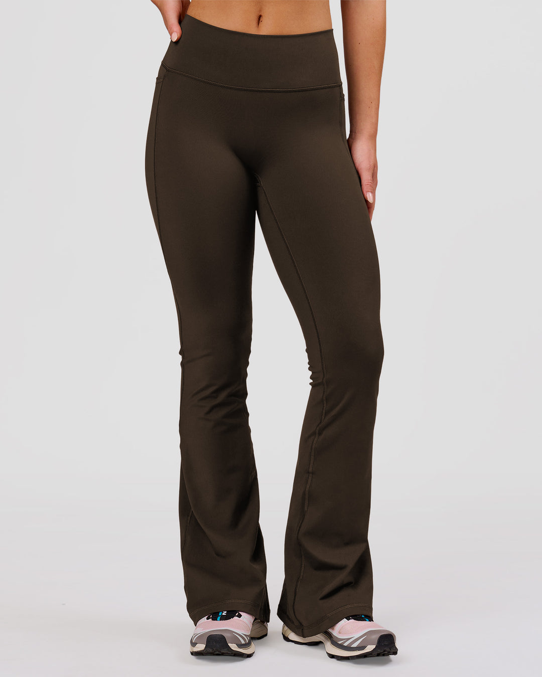 Woman wearing Fusion V-Contour High-Rise Flared Petite Legging Pockets - Ground Coffee | Model:Issy | Size:XS - view 3