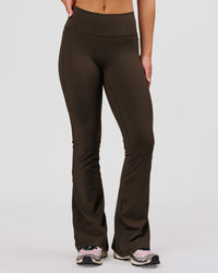 Woman wearing Fusion V-Contour High-Rise Flared Petite Legging Pockets - Ground Coffee | Model:Issy | Size:XS | Thumbnail Index: 2