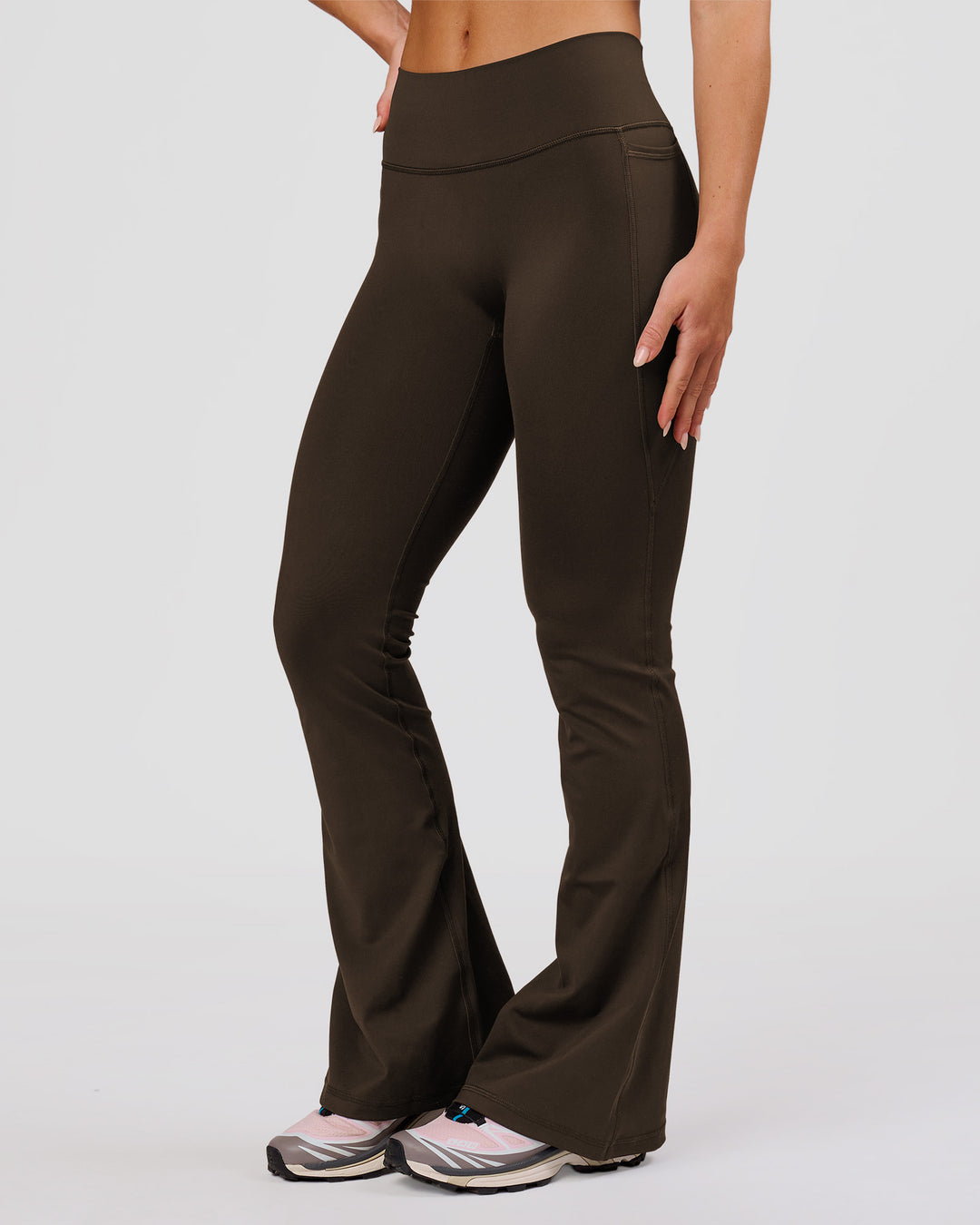 Woman wearing Fusion V-Contour High-Rise Flared Petite Legging Pockets - Ground Coffee | Model:Issy | Size:XS - view 4