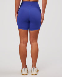 Woman wearing Fusion V-Contour Ultra High-Rise 6" Short Pockets - Power Cobalt | Model:Issy | Size:XS | Thumbnail Index: 6