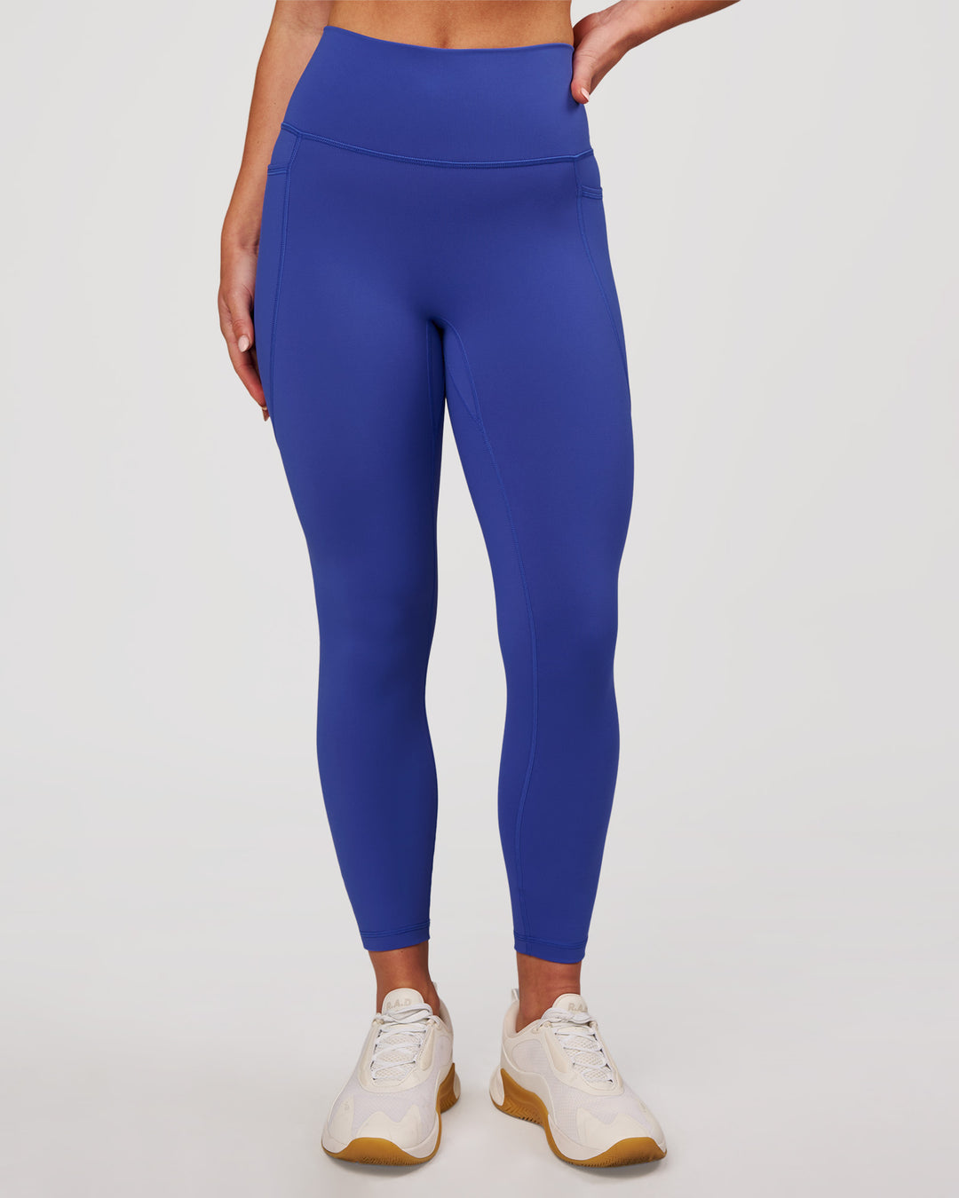 Woman wearing Fusion V-Contour Ultra High-Rise 7/8 Legging Pockets - Power Cobalt | Model:Issy | Size:XS - view 2