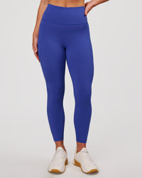 Woman wearing Fusion V-Contour Ultra High-Rise 7/8 Legging Pockets - Power Cobalt | Model:Issy | Size:XS | Thumbnail Index: 1