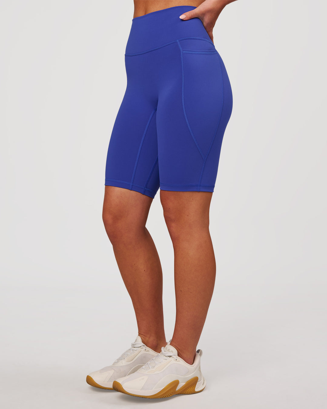 Woman wearing Fusion V Contour Ultra High-Rise 9" Short Pockets - Power Cobalt | Model:Issy | Size:XS - view 7