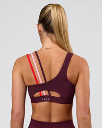 Woman wearing Galvanise Sports Bra 2.0 - Cherry Lacquer-Multi | Model:Issy | Size:XS | Thumbnail Index: 1