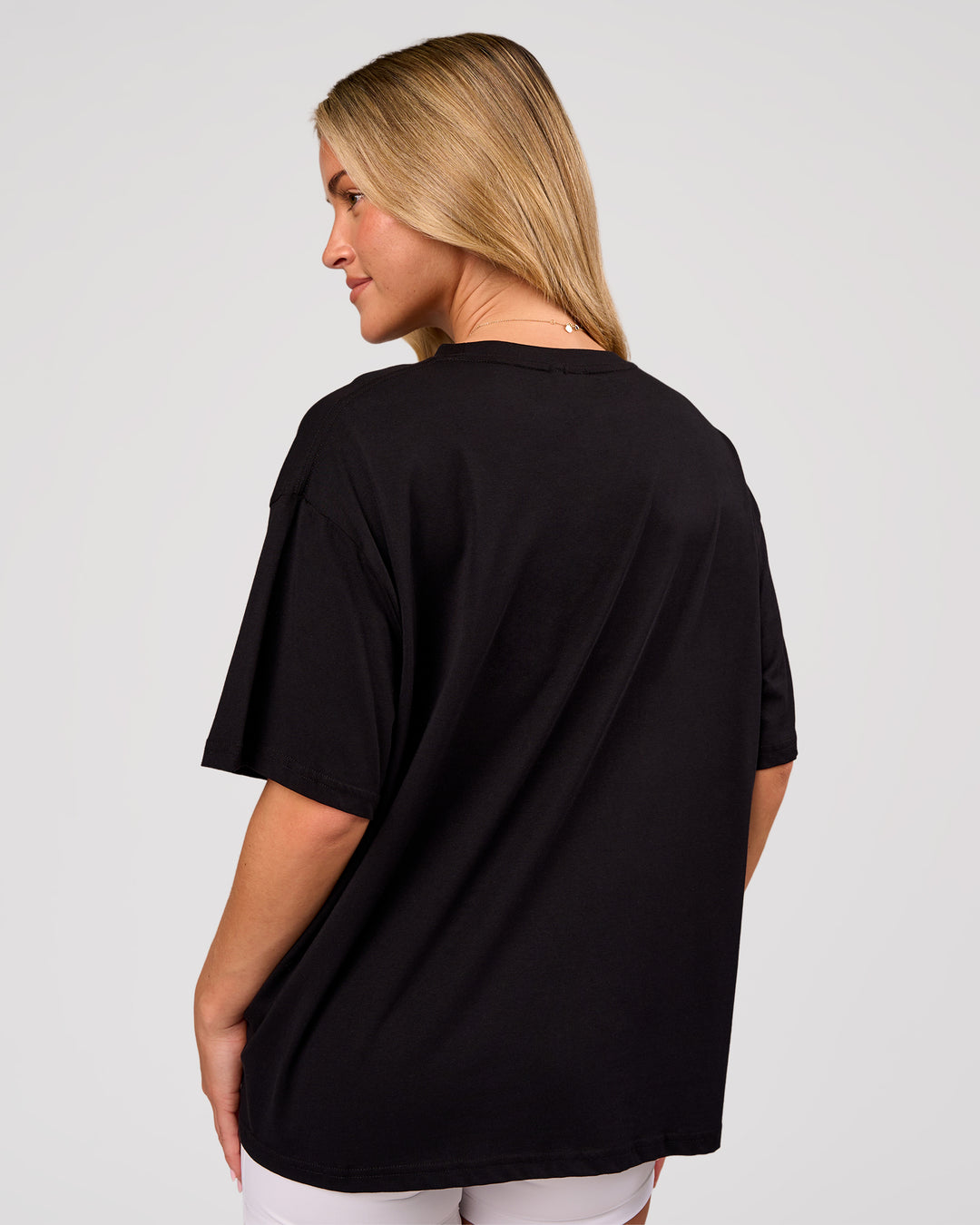 Woman wearing Go-To FLXCotton Oversized Tee - Black-White | Model:Issy | Size:XS - view 3