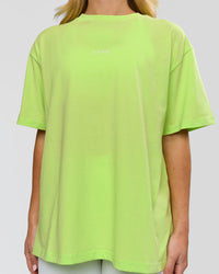 Woman wearing Go-To FLXCotton Oversized Tee - Lime Glo-White | Model:Issy | Size:XS | Thumbnail Index: 1