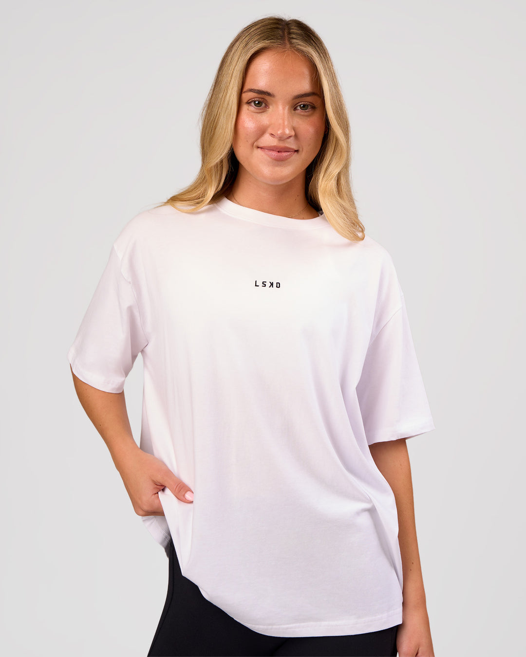Woman wearing Go-To FLXCotton Oversized Tee - White-Black | Model:Issy | Size:XS - view 1