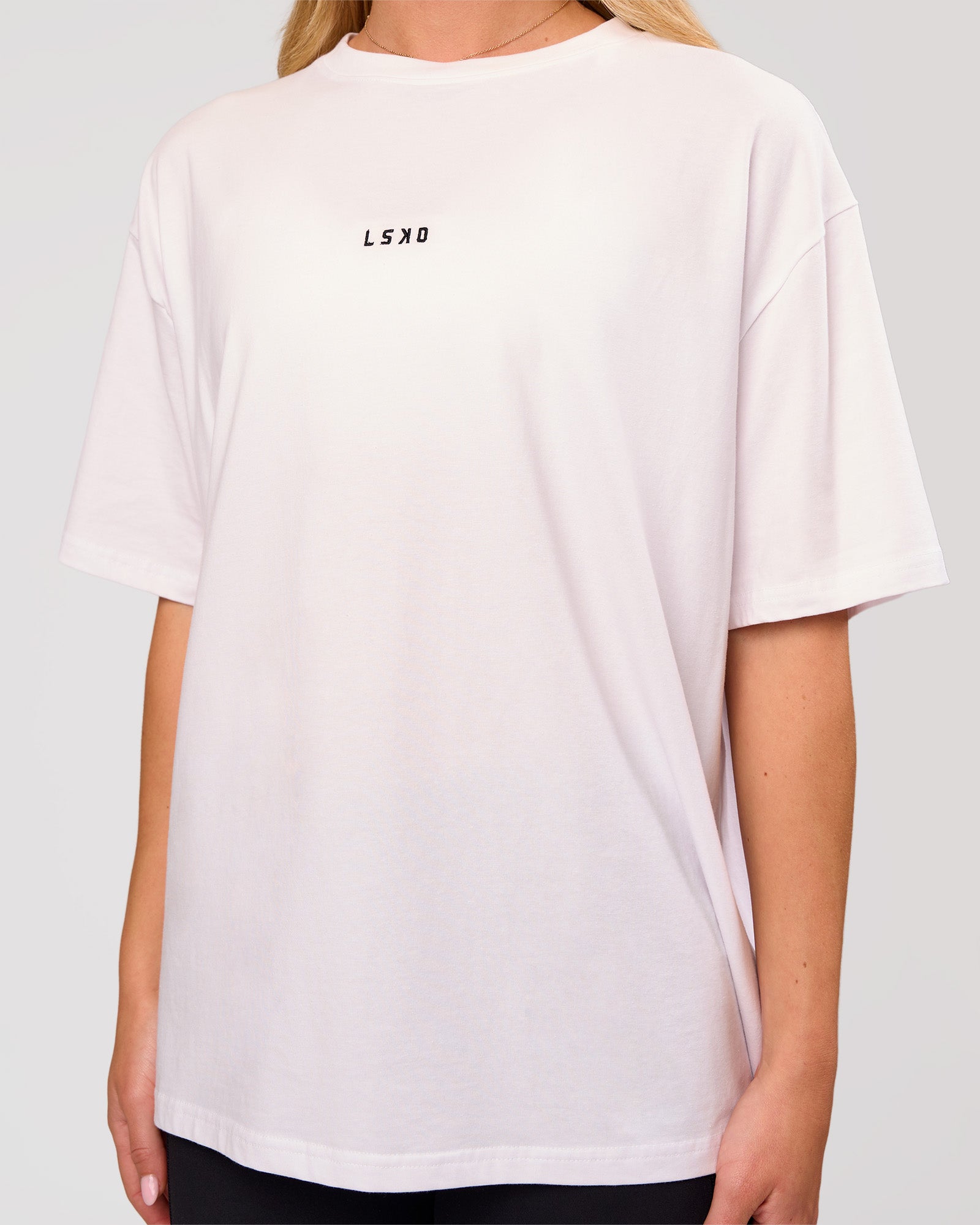 Woman wearing Go-To FLXCotton Oversized Tee - White-Black | Model:Issy | Size:XS