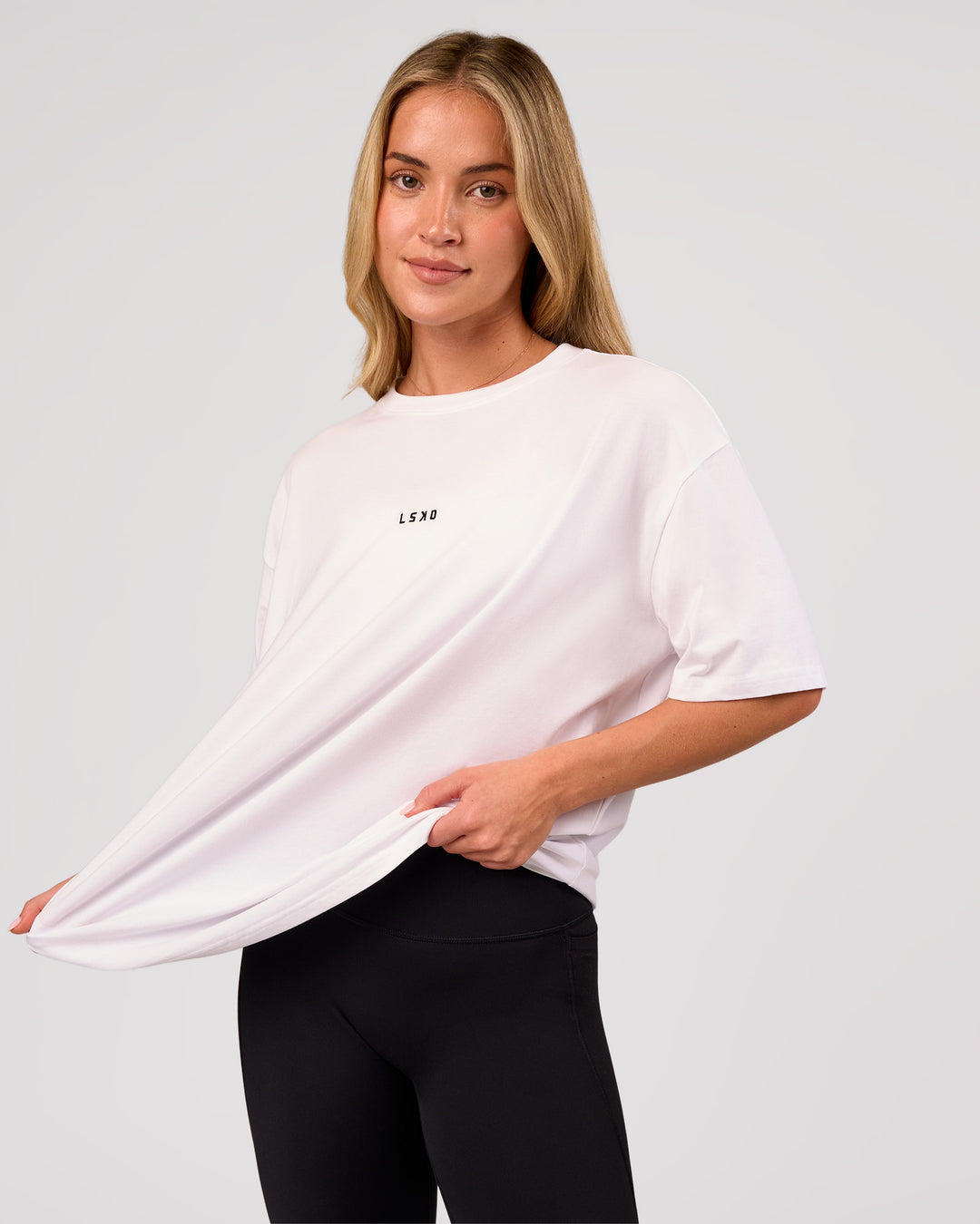 Woman wearing Go-To FLXCotton Oversized Tee - White-Black | Model:Issy | Size:XS - view 4