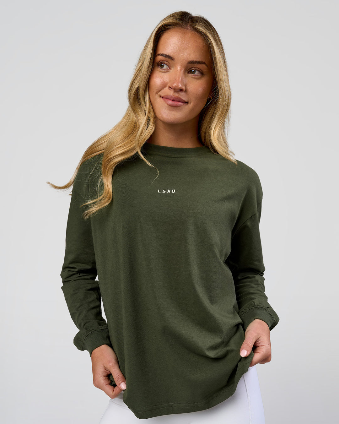 Woman wearing Go-To Long Sleeve FLXCotton Oversized Tee - Pure Olive-White | Model:Issy | Size:XS - view 1
