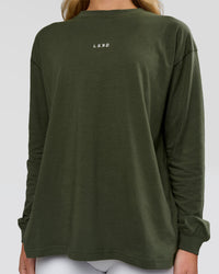 Woman wearing Go-To Long Sleeve FLXCotton Oversized Tee - Pure Olive-White | Model:Issy | Size:XS | Thumbnail Index: 2