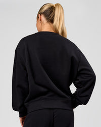 Woman wearing Go-To Oversized Sweater - Black | Model:Issy | Size:XS | Thumbnail Index: 1