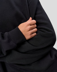 Woman wearing Go-To Oversized Sweater - Black | Model:Issy | Size:XS | Thumbnail Index: 6