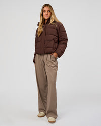 Woman wearing Go-To Puffer Jacket - Hot Chocolate | Model:Issy | Size:XS | Thumbnail Index: 1