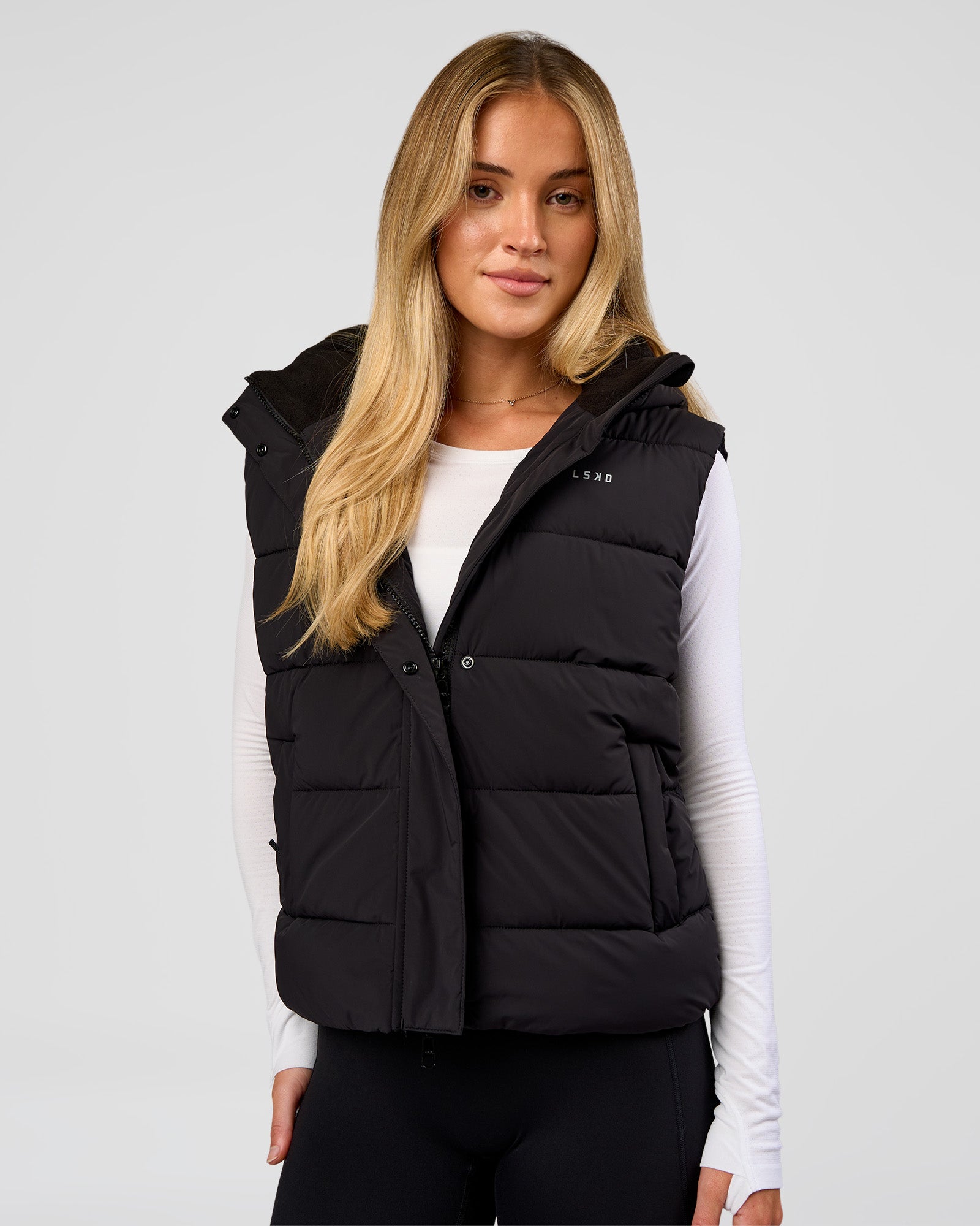 Woman wearing Go-To Puffer Vest - Black | Model:Issy | Size:XS