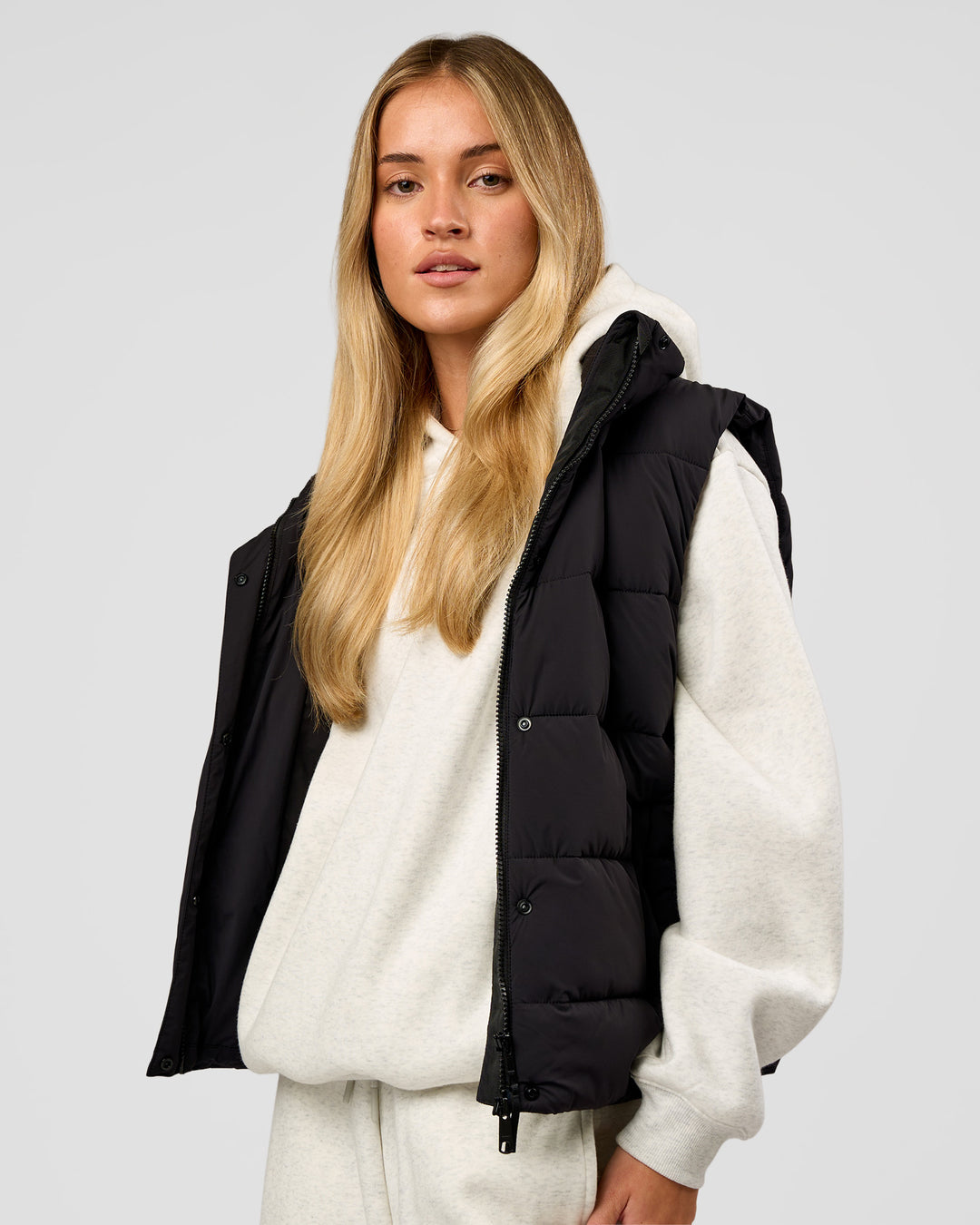Woman wearing Go-To Puffer Vest - Black | Model:Issy | Size:XS - view 8
