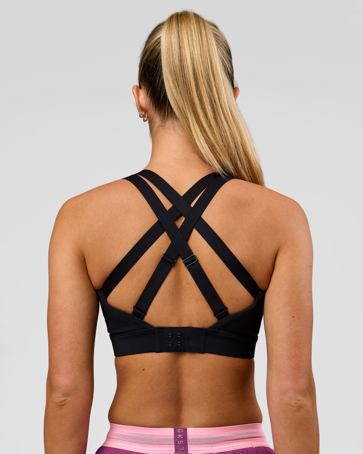 Woman wearing High Velocity Sports Bra - Black | Model:Issy | Size:XS