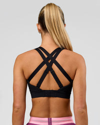 Woman wearing High Velocity Sports Bra - Black | Model:Issy | Size:XS | Thumbnail Index: 1