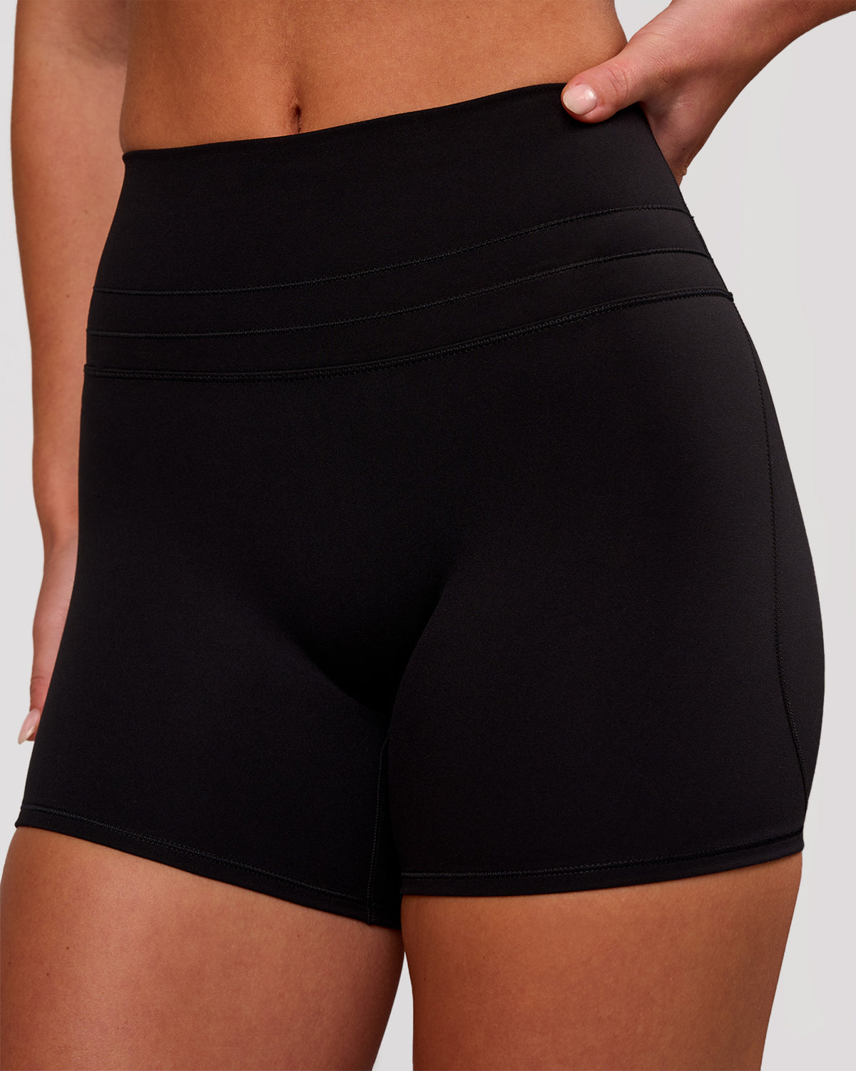 Woman wearing Luxe V-Contour High-Rise 4" Short - Black | Model:Issy | Size:XS - view 2
