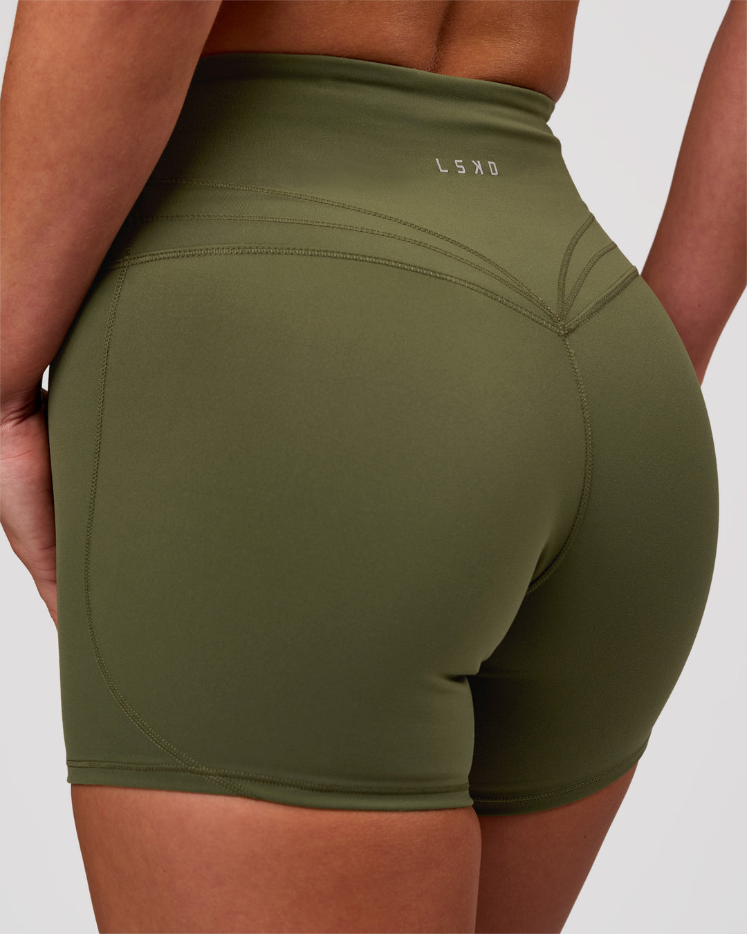 Woman wearing Luxe V-Contour High-Rise 4" Short - Pure Olive | Model:Issy | Size:XS - view 1