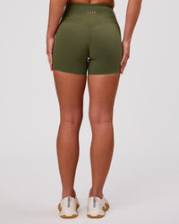 Woman wearing Luxe V-Contour High-Rise 4" Short - Pure Olive | Model:Issy | Size:XS | Thumbnail Index: 3