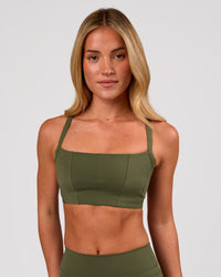 Woman wearing Momentum Corset Sports Bra - Pure Olive | Model:Issy | Size:XS | Thumbnail Index: 2