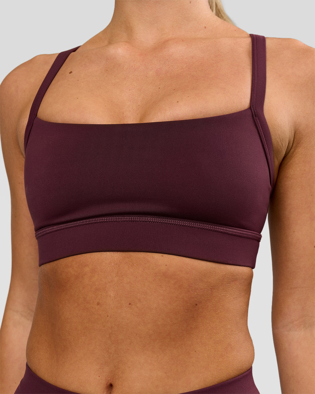 Woman wearing Momentum Sports Bra - Cherry Lacquer | Model:Issy | Size:XS - view 1