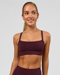 Woman wearing Momentum Sports Bra - Cherry Lacquer | Model:Issy | Size:XS | Thumbnail Index: 2