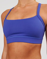 Woman wearing Momentum Sports Bra - Power Cobalt | Model:Issy | Size:XS | Thumbnail Index: 0
