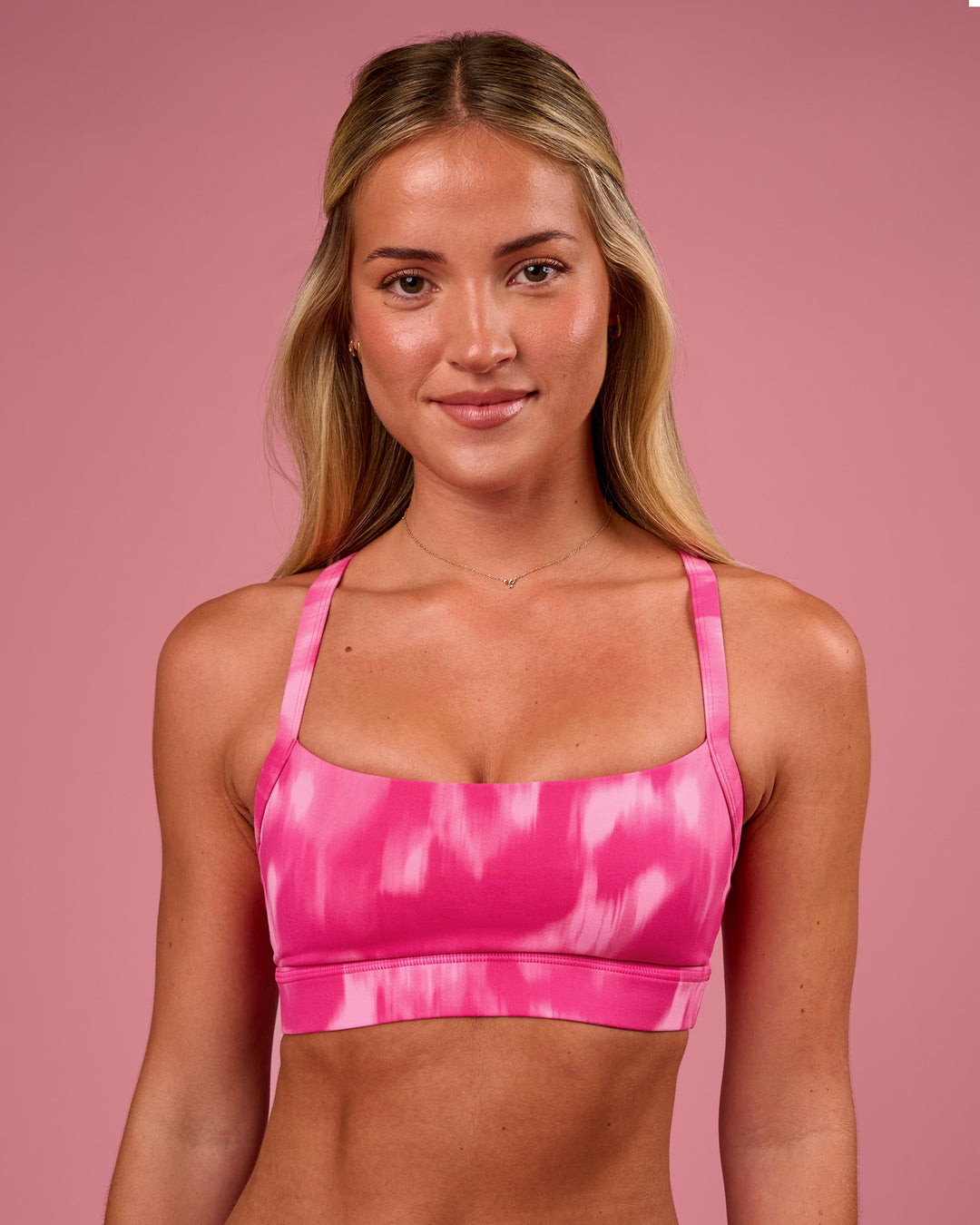 Woman wearing Momentum Sports Bra - Radiant Pink | Model:Issy | Size:XS - view 1