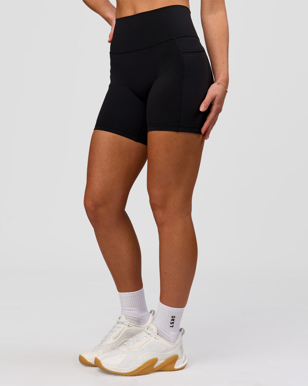 Woman wearing O.G. Fusion Ultra High-Rise 6" Short Pockets - Black | Model:Issy | Size:XS - view 12
