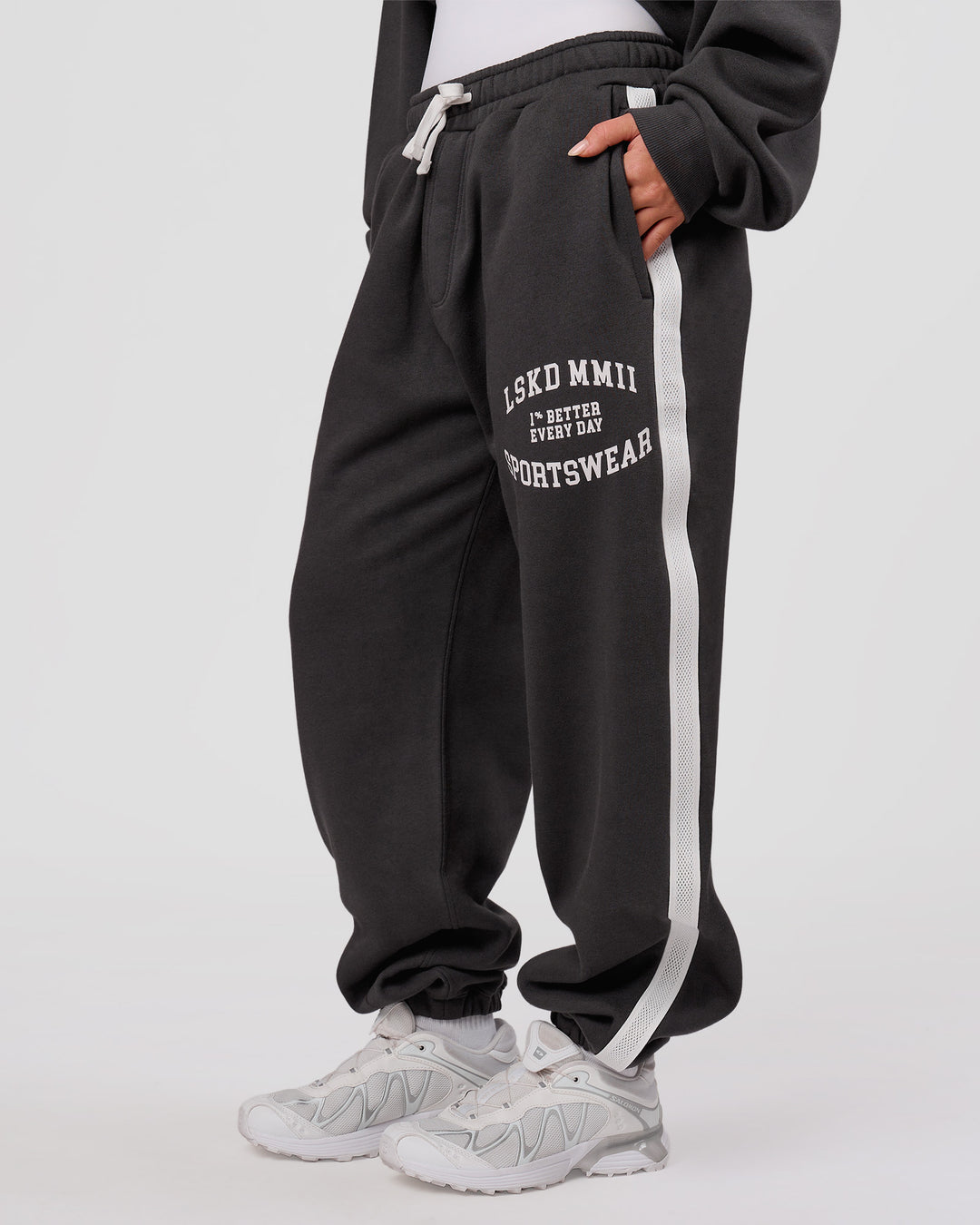 Woman wearing Playbook Baggy Cuffed Track Pant - Onyx-Off White | Model:Issy | Size:XS - view 4