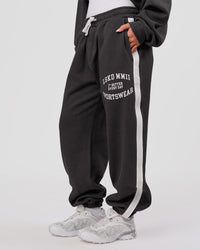 Woman wearing Playbook Baggy Cuffed Track Pant - Onyx-Off White | Model:Issy | Size:XS | Thumbnail Index: 3