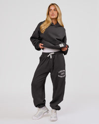 Woman wearing Playbook Baggy Cuffed Track Pant - Onyx-Off White | Model:Issy | Size:XS | Thumbnail Index: 1