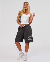 Woman wearing Playbook Varsity Fleece Shorts - Onyx-Off White | Model:Issy | Size:XS | Thumbnail Index: 0