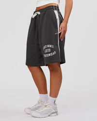 Woman wearing Playbook Varsity Fleece Shorts - Onyx-Off White | Model:Issy | Size:XS | Thumbnail Index: 17