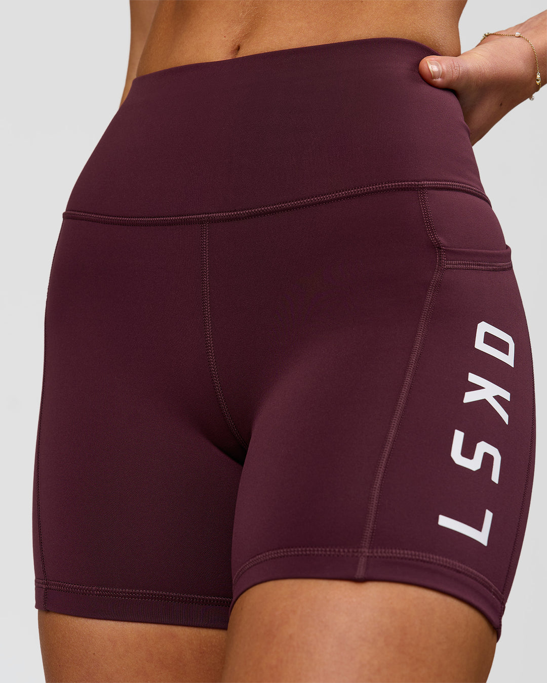 Woman wearing Rep Ultra High-Rise 4" Short Pockets - Cherry Lacquer-White | Model:Issy | Size:XS - view 1