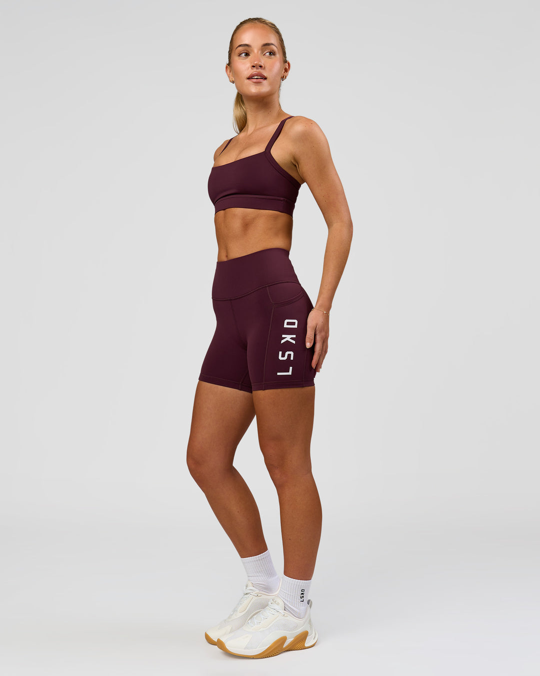 Woman wearing Rep Ultra High-Rise 4" Short Pockets - Cherry Lacquer-White | Model:Issy | Size:XS - view 3