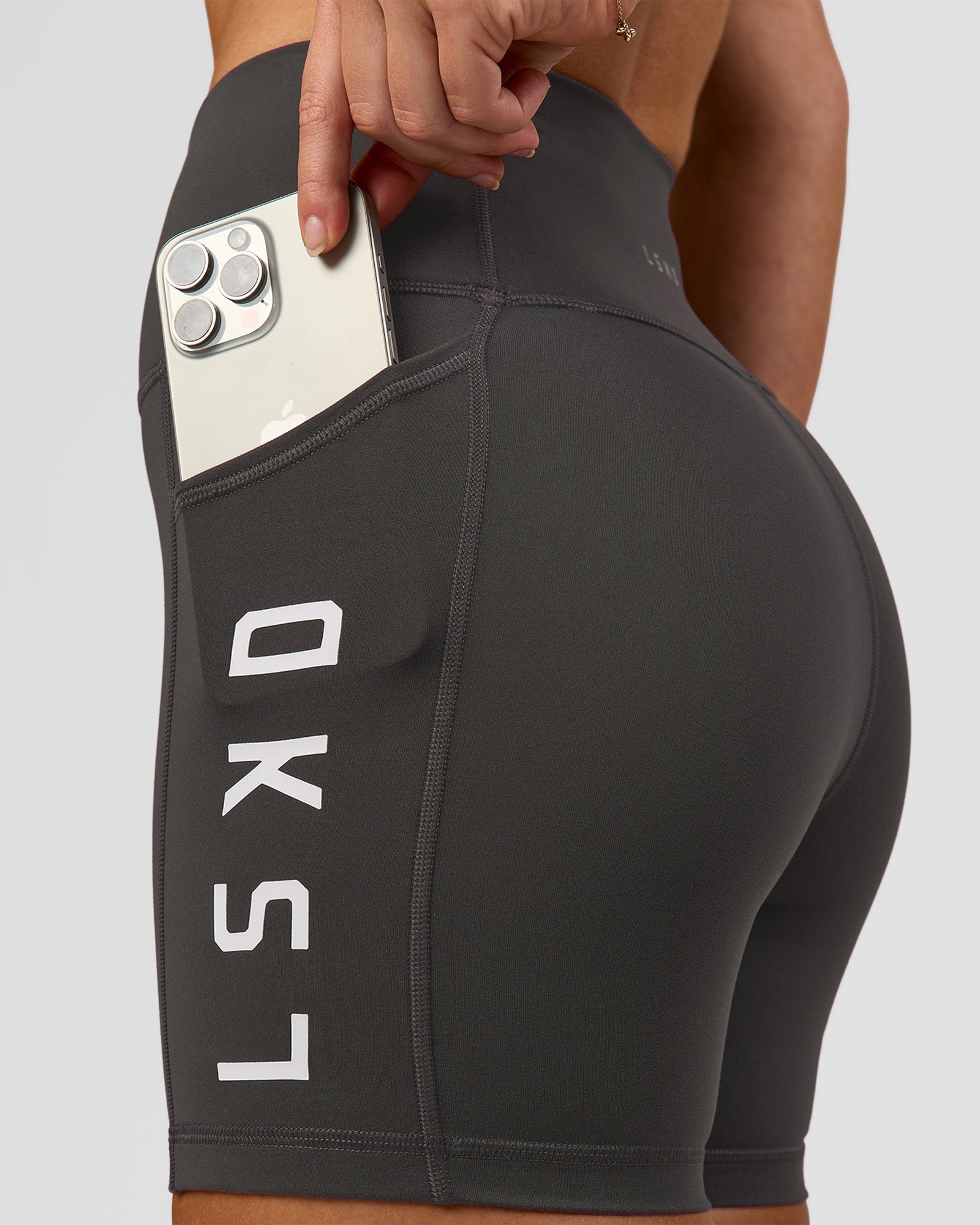 Woman wearing Rep Ultra High-Rise 4" Short Pockets - Onyx-White | Model:Issy | Size:XS