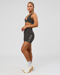 Woman wearing Rep Ultra High-Rise 4" Short Pockets - Onyx-White | Model:Issy | Size:XS | Thumbnail Index: 2