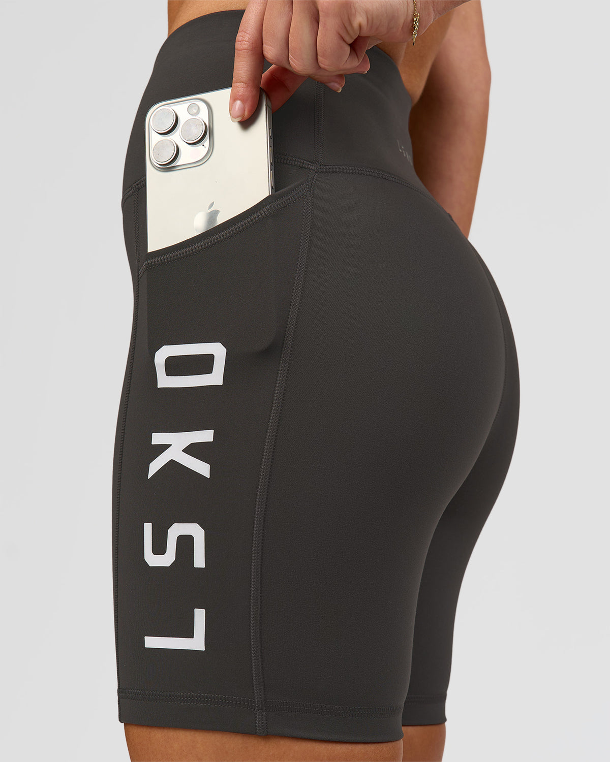 Woman wearing Rep Ultra High-Rise 6" Short Pockets - Onyx-white | Model:Issy | Size:XS