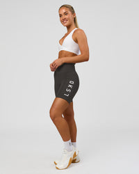 Woman wearing Rep Ultra High-Rise 6" Short Pockets - Onyx-white | Model:Issy | Size:XS | Thumbnail Index: 1