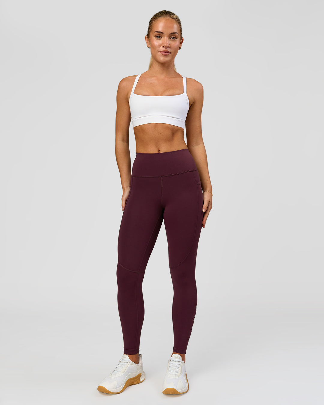 Woman wearing Rep Ultra High-Rise 7/8 Legging Pockets - Cherry Lacquer-White | Model:Issy | Size:XS - view 1