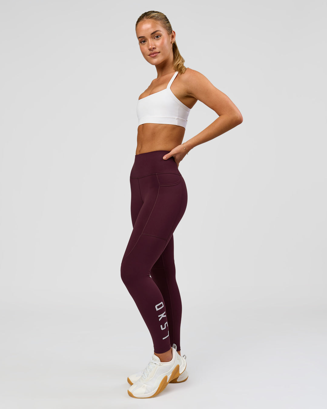 Woman wearing Rep Ultra High-Rise 7/8 Legging Pockets - Cherry Lacquer-White | Model:Issy | Size:XS - view 2